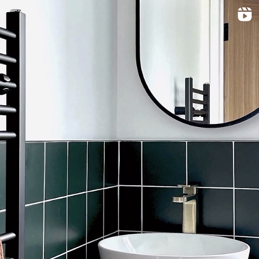 Green and white bathroom renovation with brushed brass tap and shower