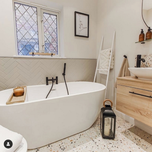 Arvan black bath shower mixer over a freestanding bath