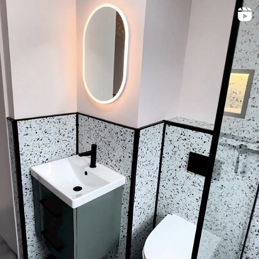 Terrazo bathroom design with black taps, showers and wetroom screen, with Deco green vanity unit
