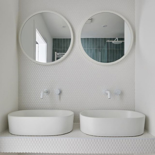 A contemporary bathroom with two ceramic vessels